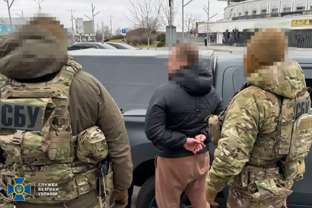 Law enforcement taking a suspect into custody.